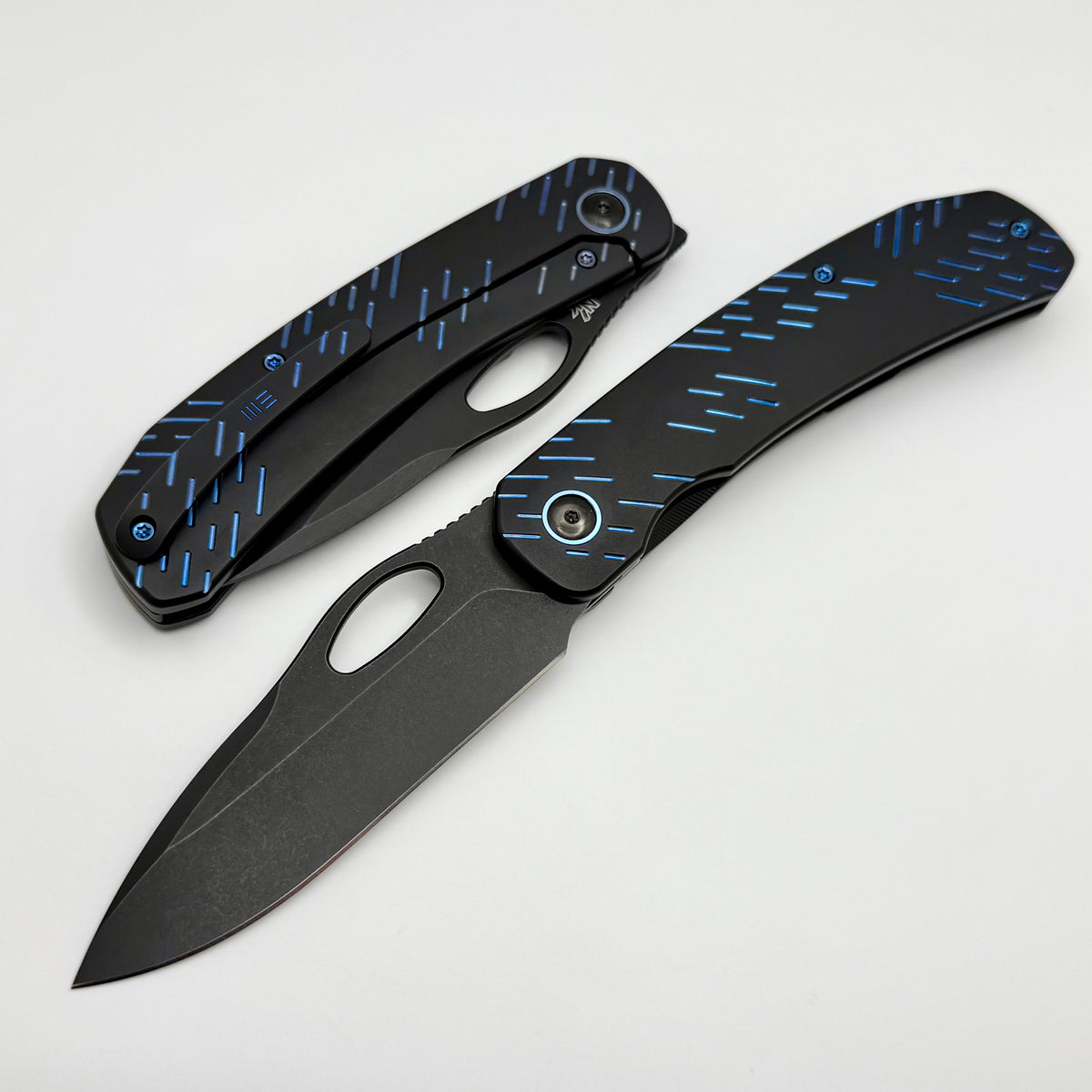 We Knife Inmate Black Titanium w/ Blue Raindrops Handles w/ Black Ston